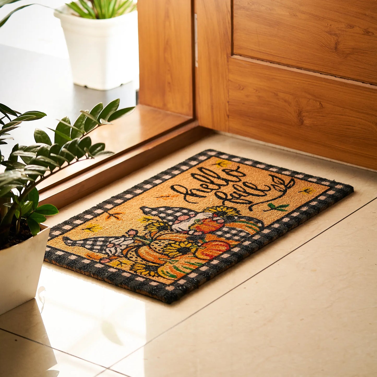 Decorative doormat with autumn design and 'Hello Fall' text on a tiled floor.