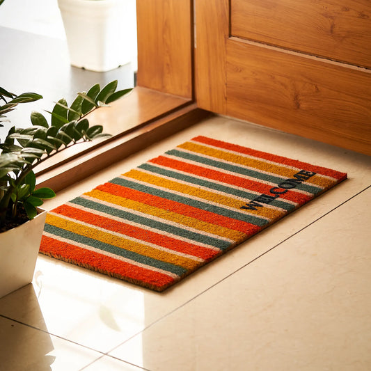 Striped welcome mat on a tiled floor next to a wooden door