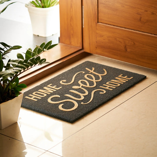 Doormat with 'Home Sweet Home' text on a wooden floor.