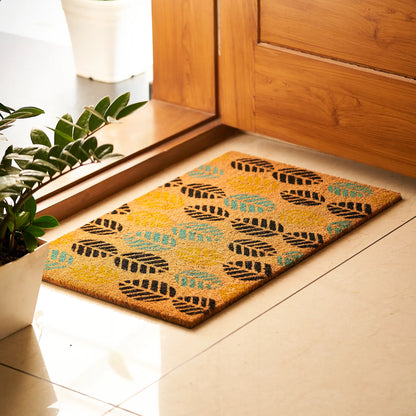 Decorative doormat with leaf pattern on a wooden floor