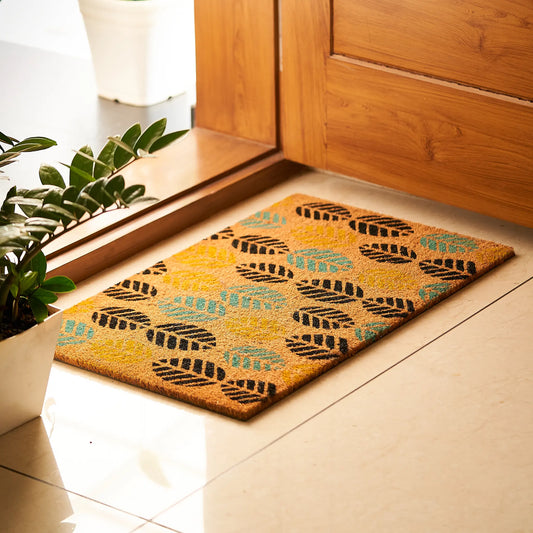 Decorative doormat with leaf pattern on a wooden floor