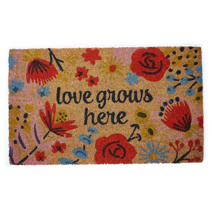 Doormat with floral design and 'love grows here' text on a white background